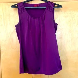 Purple sleeveless blouse.